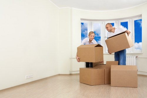 Professional movers carrying furniture through a Pimlico street