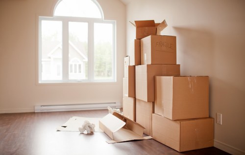 Packed moving boxes and furniture ready for transport in Pimlico
